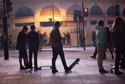 People in illuminated city at night