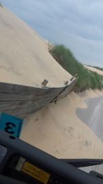 Close-up of boat on beach against sky