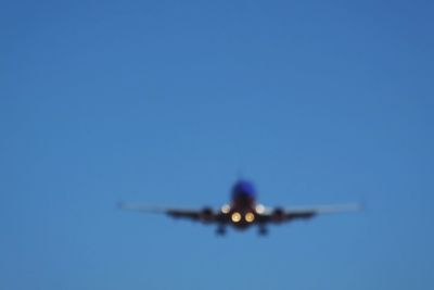 Low angle view of airplane flying in sky