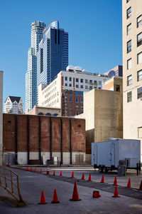 Buildings in city against clear blue sky