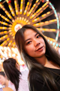 Portrait of a beautiful young woman in amusement park