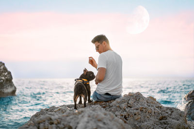 Side view of woman with dog on beach