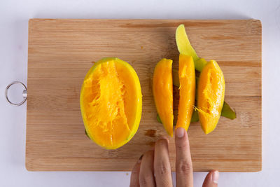 High angle view of orange slices on cutting board