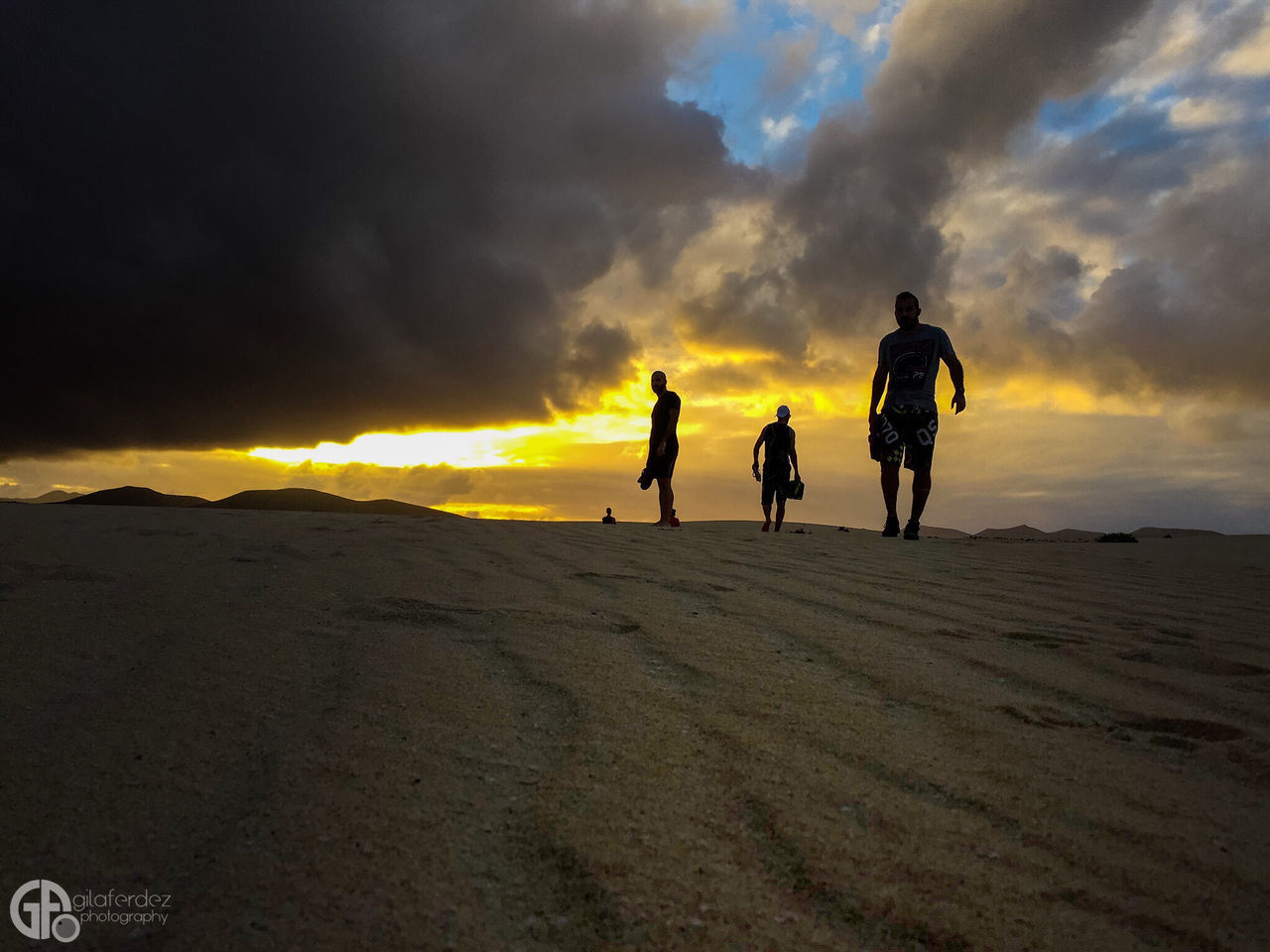 sunset, sky, full length, lifestyles, leisure activity, cloud - sky, men, walking, orange color, cloudy, rear view, standing, landscape, sand, togetherness, scenics, nature