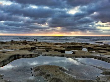 Scenic view of sea against cloudy sky