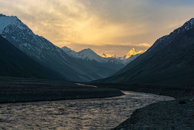 Scenic view of snowcapped mountains against sky during sunset 