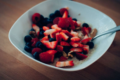 High angle view of chopped fruits in bowl on table