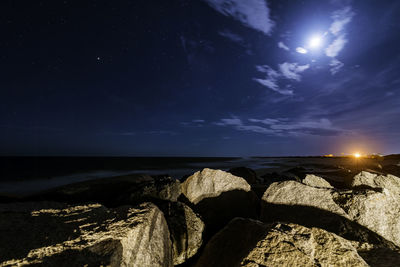 Scenic view of sea against sky at night