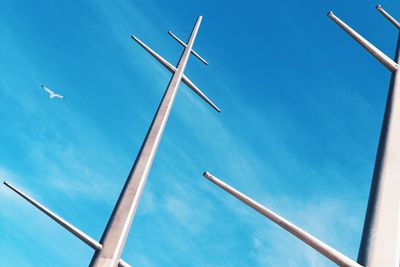 Low angle view of crane against blue sky