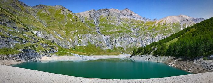 Scenic view of lake and mountains against sky