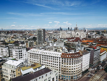 Aerial view of cityscape against sky during sunny day