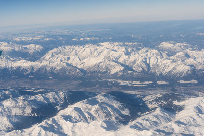 Aerial view of snowcapped mountains against sky