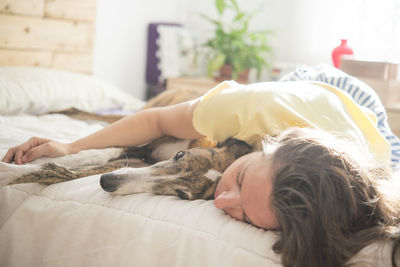 Portrait of young woman sleeping on bed at home