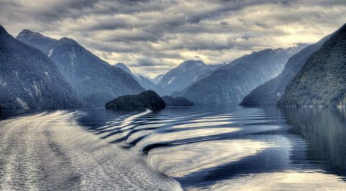 Scenic view of lake and mountains against sky