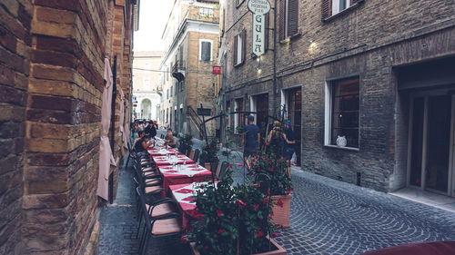 People on street amidst buildings in city