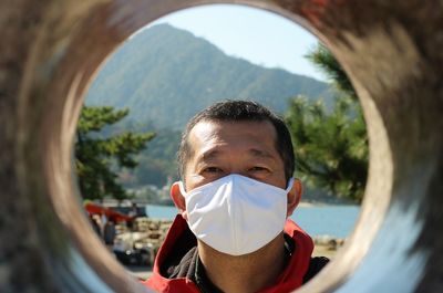 Close-up portrait of man wearing a mask 