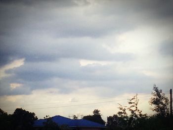 Low angle view of silhouette trees against sky