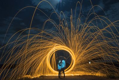 Full length of light trails against sky at night