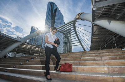 Low angle view of man on staircase against sky