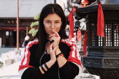 Portrait of young woman holding camera