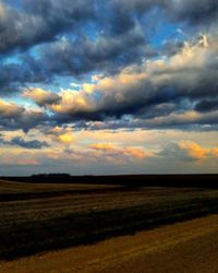 Scenic view of field against sky during sunset