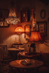 Close-up of illuminated lamp on table at home