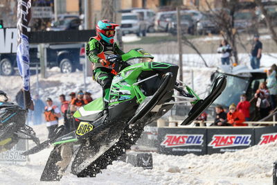 Low angle view of man snowmobiling during winter