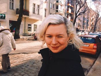 Close-up of smiling young woman on road