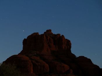 Low angle view of rock formation against sky