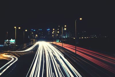 High angle view of light trails on highway at night