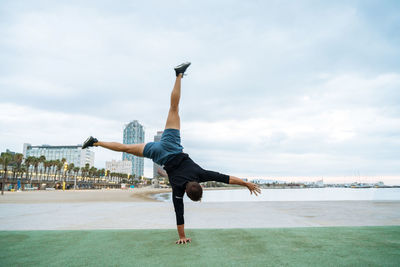 Full length of woman jumping against sky