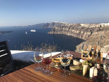 Panoramic view of people on table by mountain against sky