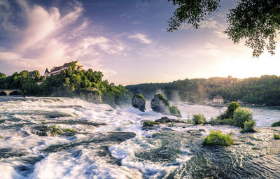 Scenic view of river against sky during sunset