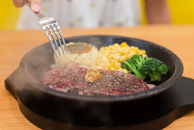 Meat steak with vegetable put on hot plate after cook make steam flow over.