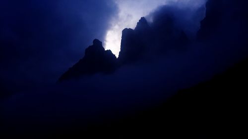 Low angle view of silhouette mountain against sky