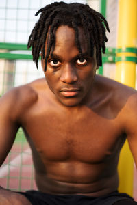 Close-up portrait of shirtless young man