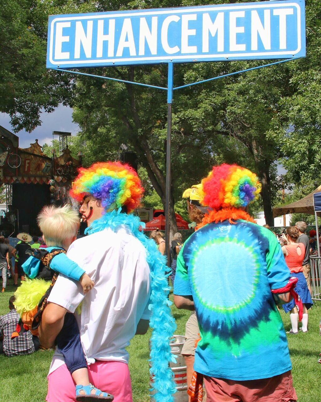 REAR VIEW OF PEOPLE STANDING AGAINST MULTI COLORED MUSIC