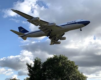 Low angle view of airplane flying against sky