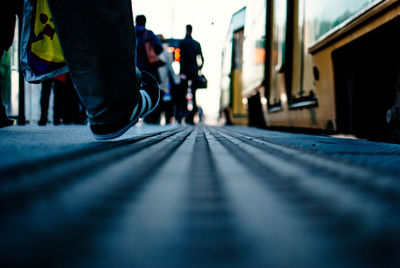 Surface level of man walking by tramway