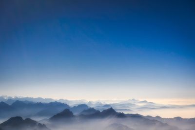 Scenic view of mountains against sky at sunset