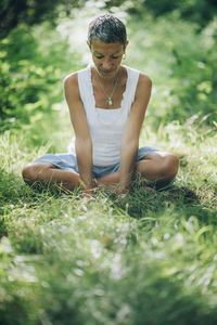 Connection with nature. a mindful woman sitting on the ground, surrounded by beautiful nature