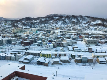 High angle view of snow covered cityscape