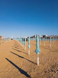 Scenic view of beach against clear blue sky