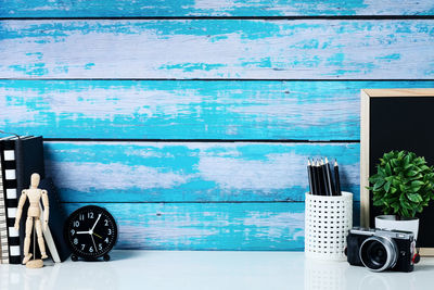 Close-up of old telephone on table against wall