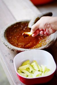 Cropped hand dipping french fries