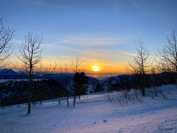 Scenic view of snow field against sky during sunset