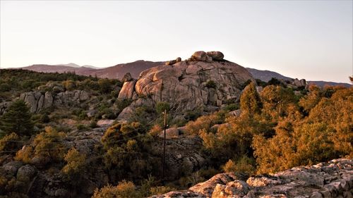 Rock formations on landscape against sky