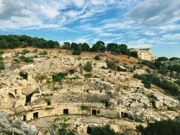 Low angle view of old ruin building against cloudy sky