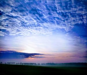 Scenic view of field against sky during sunset