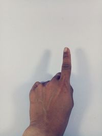 Close-up of hand against wall